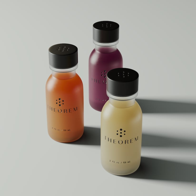 Three Theorem 2 oz wellness shots in orange, amber and deep purple